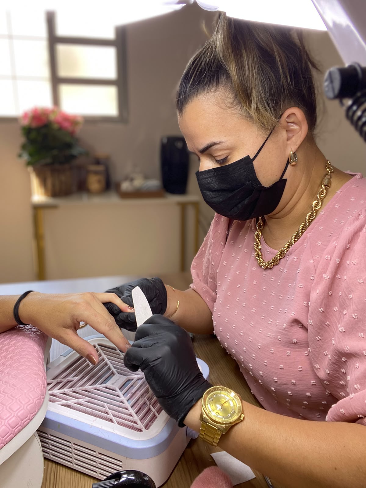 Gi Sensato realizando atendimento de unhas